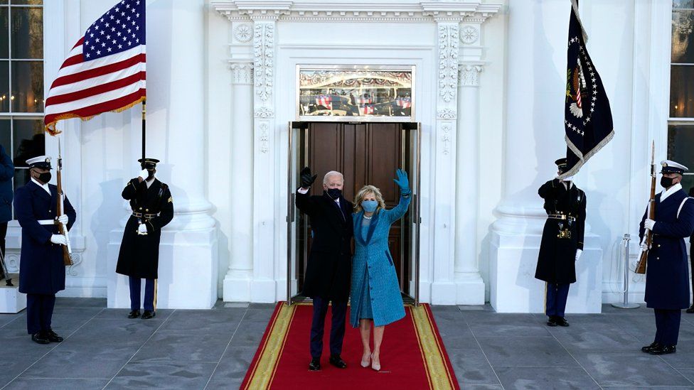 President Joe Biden and First Lady Dr Jill Biden wave on the steps of The White House
