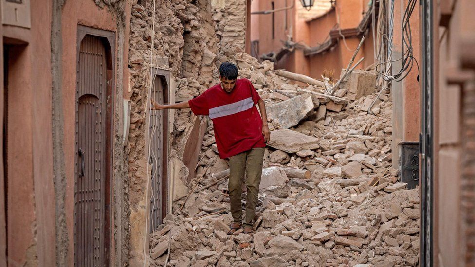 A man walks through rubble in Marrakesh