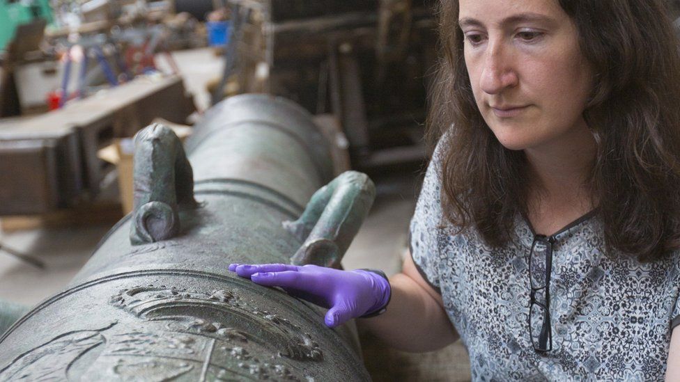 Diana Davis, senior conservator at The National Museum of the Royal Navy with one of Victory's cannon