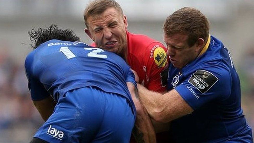 Hadleigh Parkes of Scarlets is tackled by Isa Nacewa and Sean Cronin of Leinster