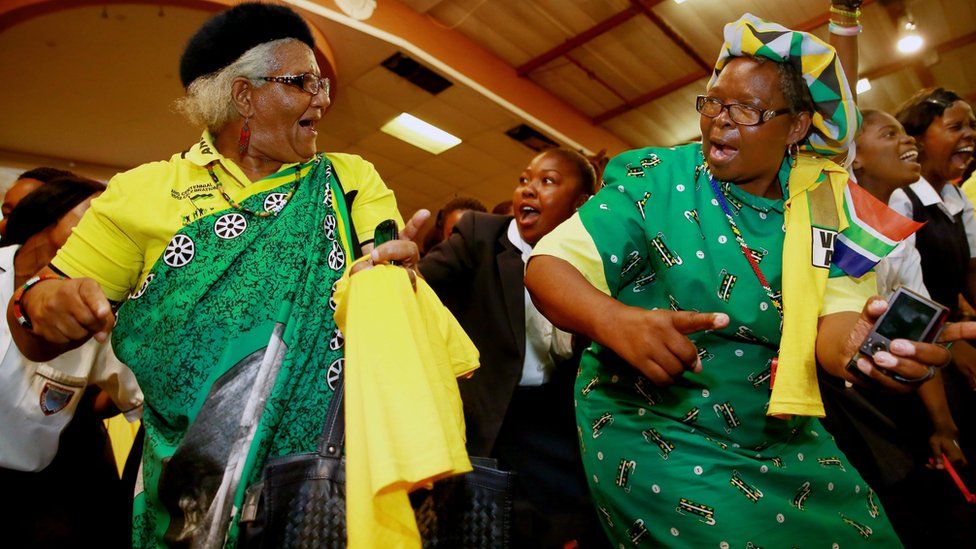 Supporters of the ruling South African political party the African National Congress (ANC) dance and sing before the arrival of the South African president and president of the African National Congress (ANC) during a campaign event at the Inter-fellowship Church in Wentworth township, outside of Durban, on April 9, 2014, ahead of elections on May 7
