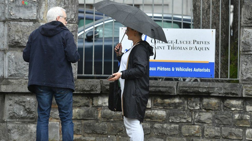 People stand outside the St Thomas d'Aquin school in south-west France