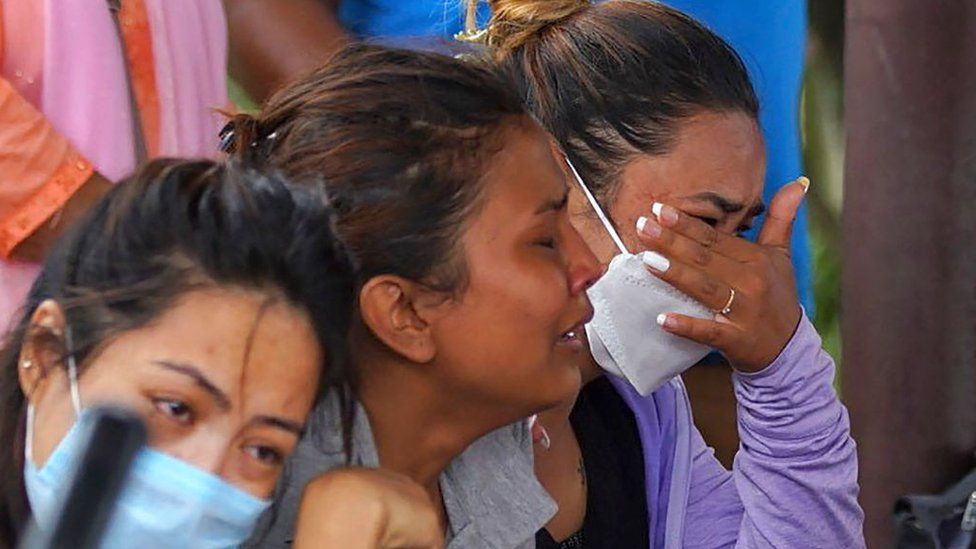 Family members and relatives of passengers on board the Twin Otter aircraft operated by Tara Air, weep outside the airport in Pokhara on May 29, 2022.