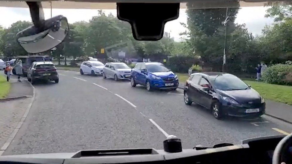 Cars blocking double yellow lines outside a school