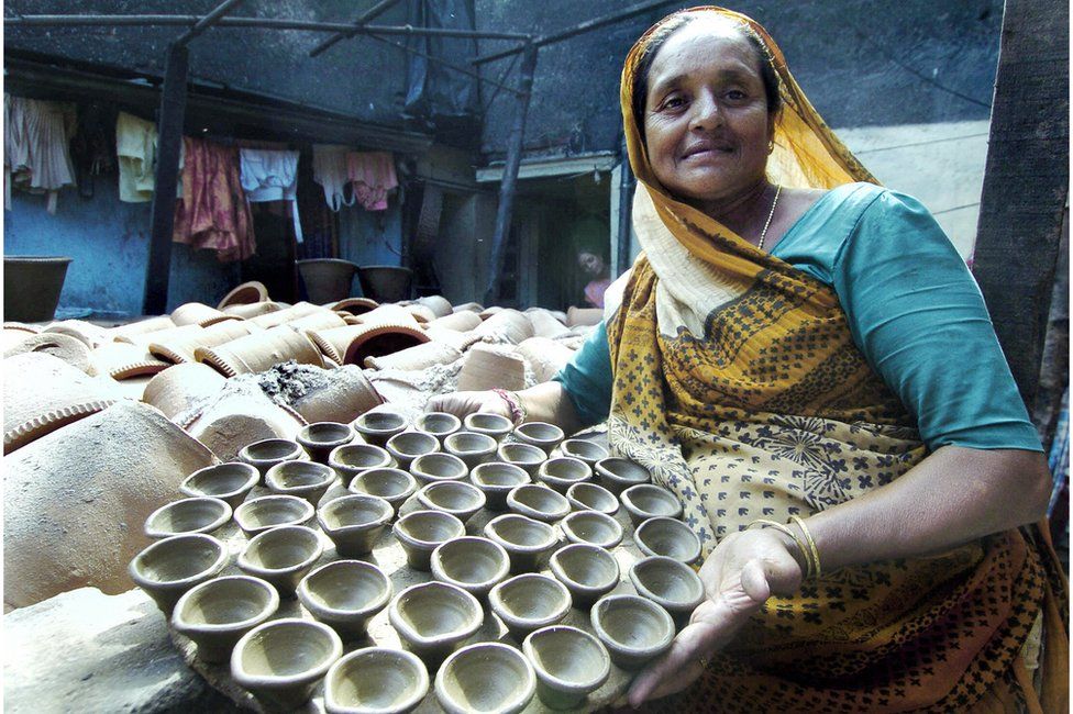 A potter with clay tea cups