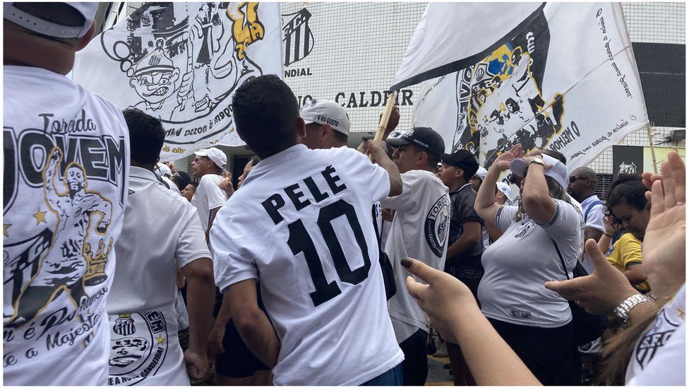 Pele supporters wave flags