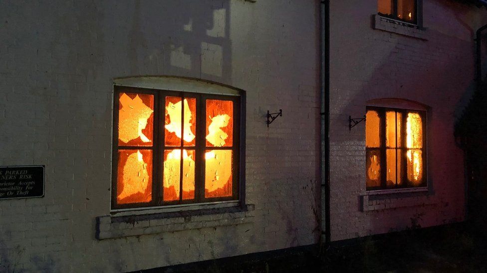 The blaze visible through the pub windows