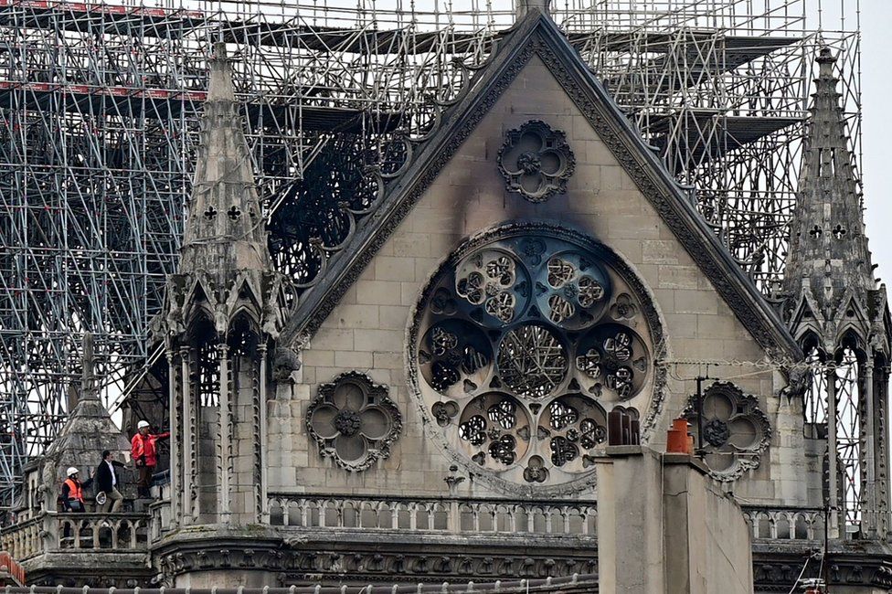 Inspectors are seen on the roof of Notre-Dame Cathedral