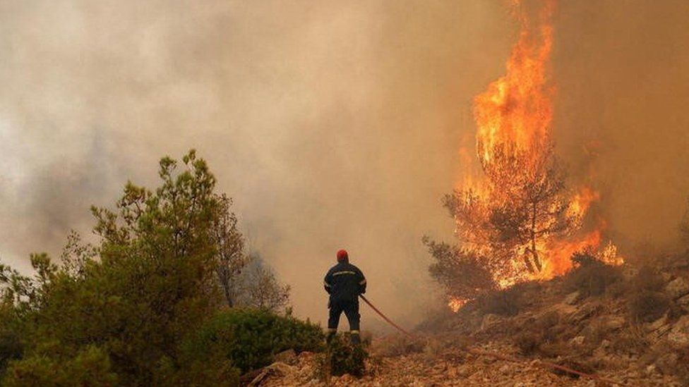 A firefighter tackles a wildfire in a fire near Athens, Greece. Photo: 19 July 2023