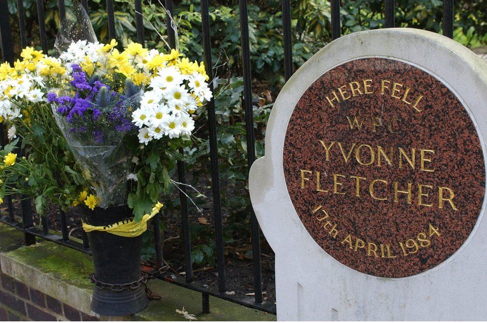 Flowers beside the memorial plaque for Yvonne Fletcher