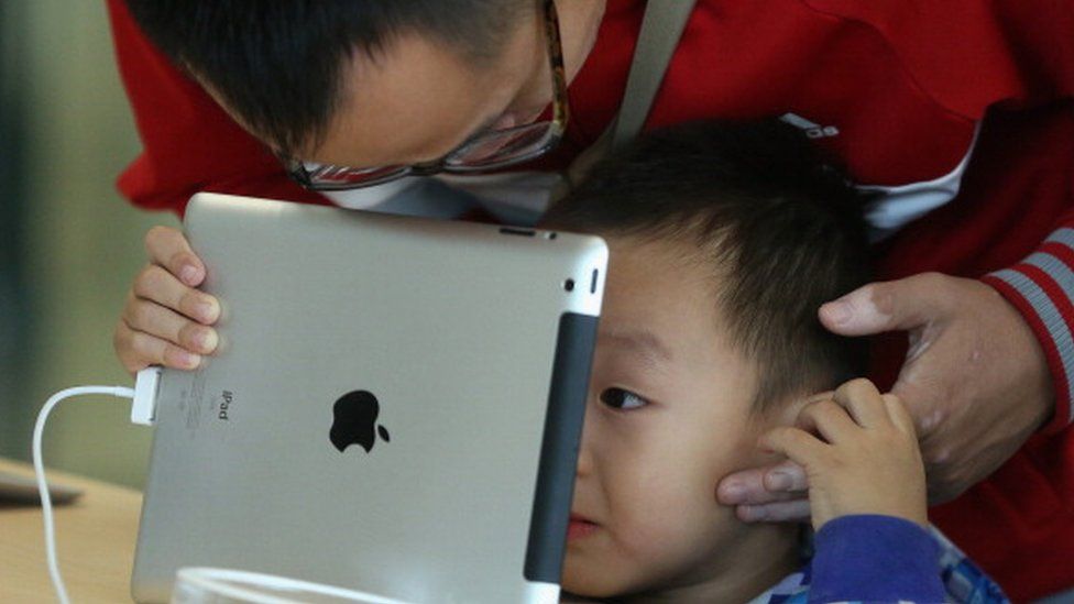 A child looking at an iPad