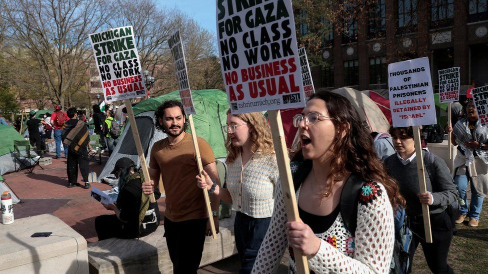 Students marching and holding signs