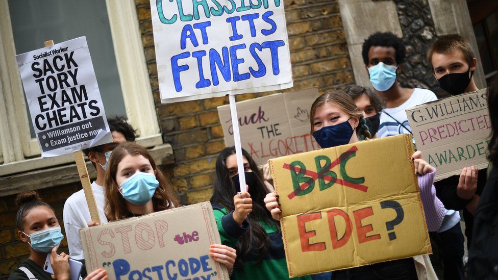 People take part in a protest outside in London over the government"s handling of A-level results.
