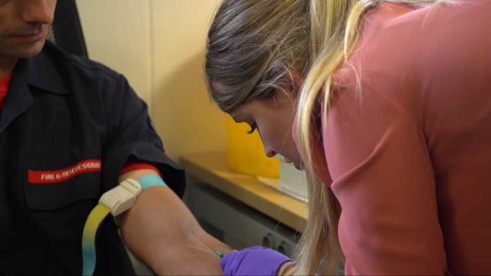 Doctor Emily Watkins taking taking a blood sample