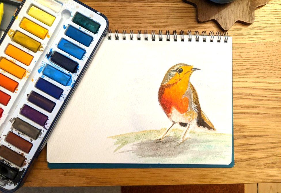 Paintbox with painting of a robin
