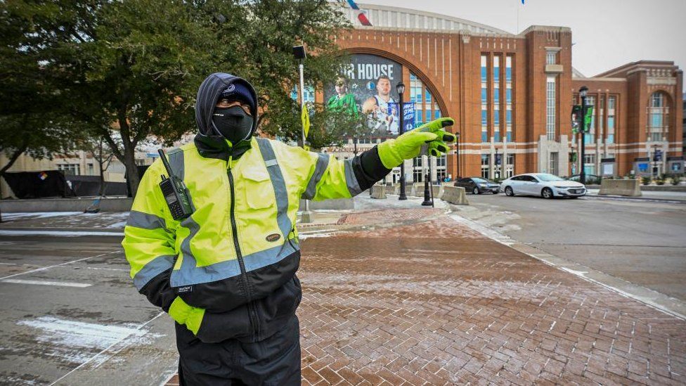 A Dallas police officer directs traffic in front of the arena before the game between the Dallas Mavericks and the New Orleans Pelicans at the American Airlines Center.