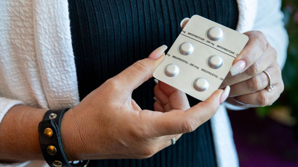 Woman holding pills