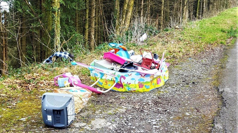 A paddling pool and TV dumped in a lay-by