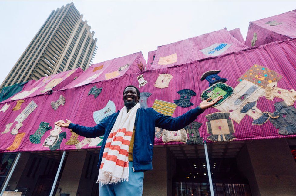 Ghanaian artist Ibrahim Mahama poses for a photograph in front of his installation entitled 'Purple Hibiscus' at the Barbican centre in central London on April 9, 2024.