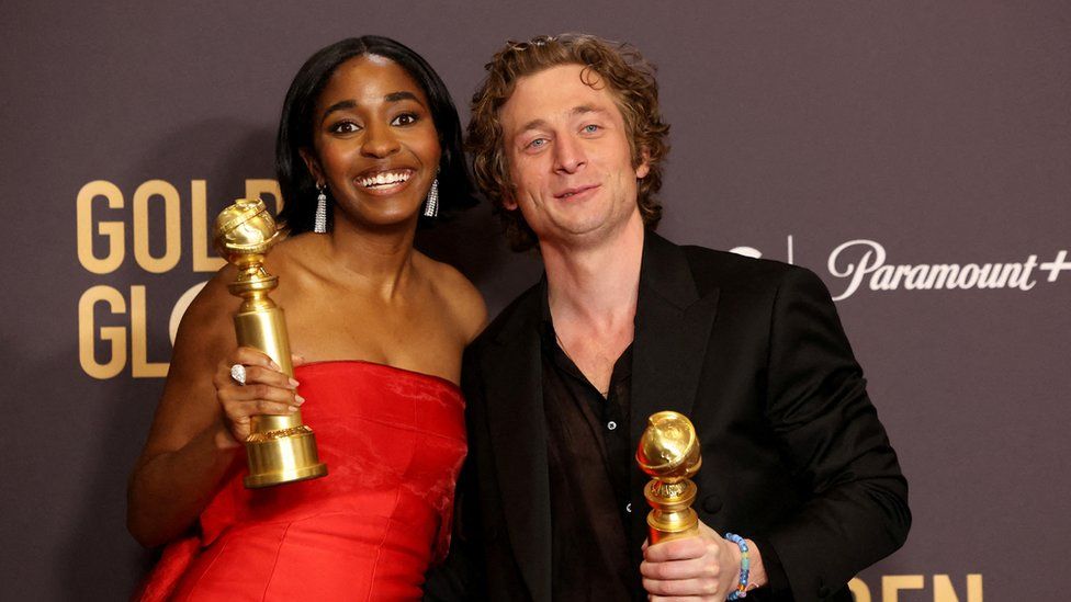 Ayo Edebiri and Jeremy Allen White clutching their Golden Globes