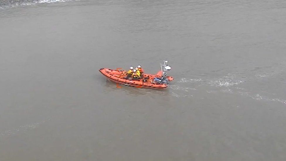 An aerial view of coastguards in action