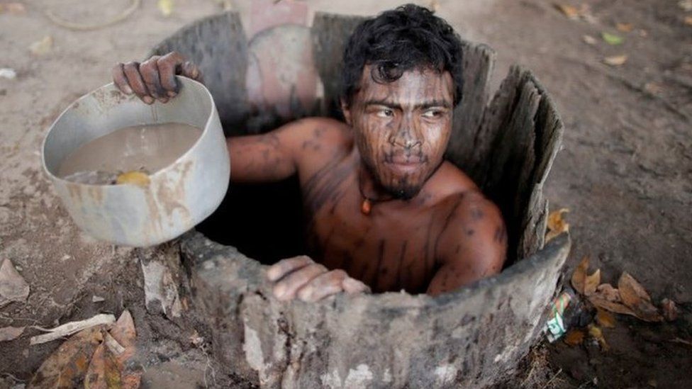 Paulo Paulino Guajajara draws water from a well at a loggers camp on Arariboia indigenous land near the city of Amarante, Maranhao state, Brazil.