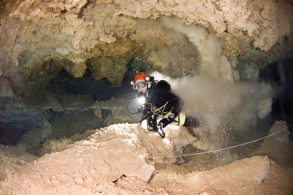 Xisco Gracia kicking up silt in an underwater cavern