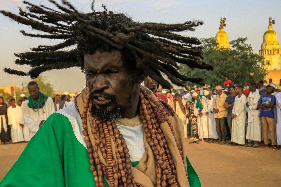 A man dances during a Sufi Muslim "dhikr" (prayer) ritual at the cemetery of the 19th-century Sufi leader Sheikh Hamad-al Nile -- leader of the Qadiriyah tariqa (order) -- in Omdurman, the twin-city of Sudan's capital, on September 23, 2022