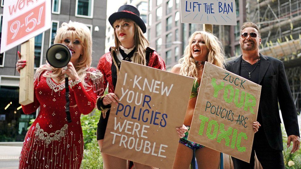 Dolly Parton, Taylor Swift, Britney Spears and George Michael impersonators, with the Taylor Swift tribute holding a sign reading andquot;I knew your policies were trouble"