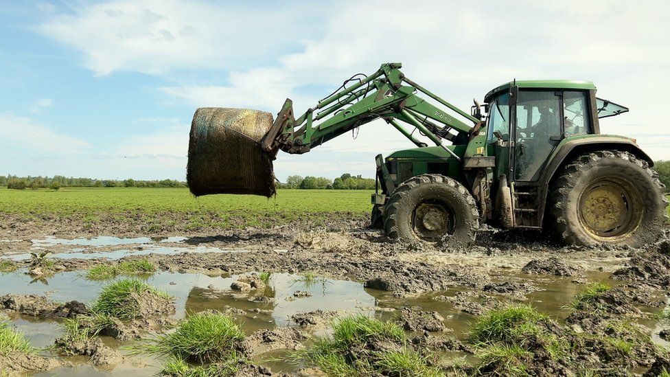 Tractor in flooded field