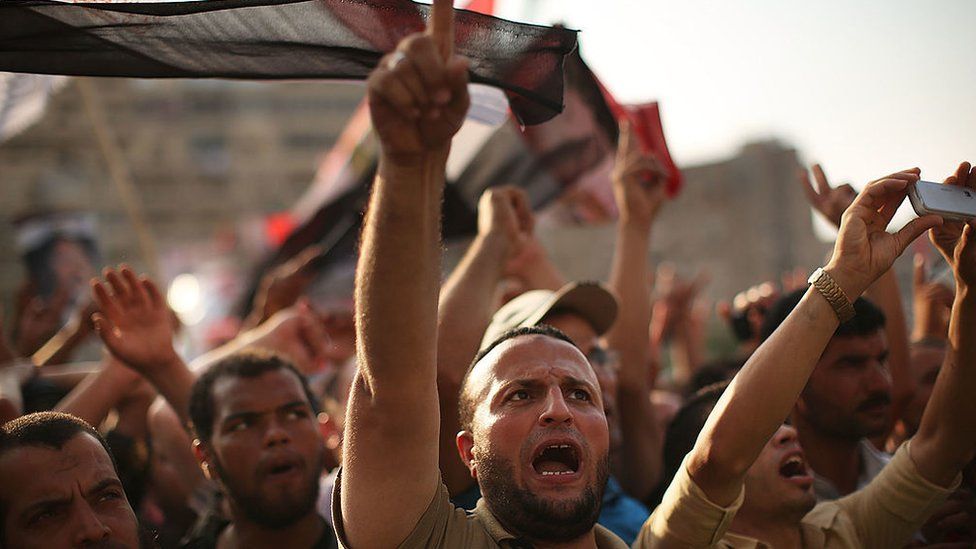 Pro Mohammed Morsi supporters rally near where over 50 were purported to have been killed by members of the Egyptian military and police in early morning clashes on July 8, 2013 in Cairo, Egypt.
