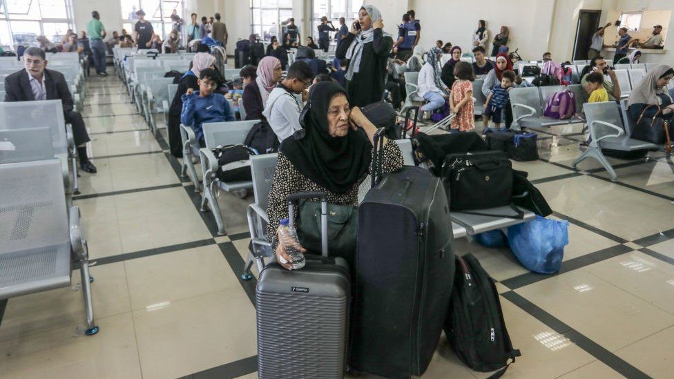 Palestinians with foreign passports wait at the Rafah crossing