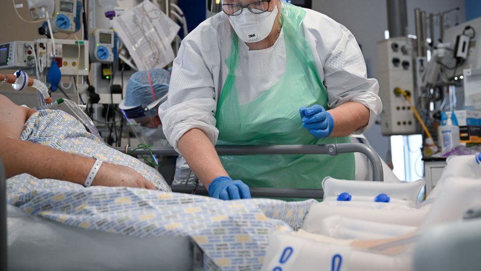 A member of staff at University Hospital Monklands attends to a Covid-positive patient on the ICU ward on February 5, 2021 in Airdrie