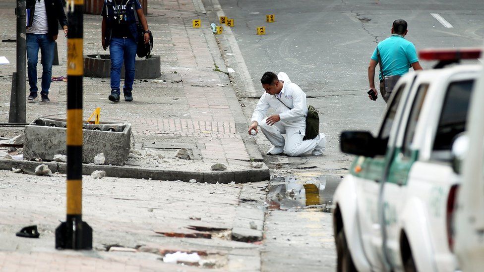 Crime scene investigators of the Colombian Police examine the area of an explosion in the La Macarena neighborhood of Bogota, Colombia, 19 February 2017