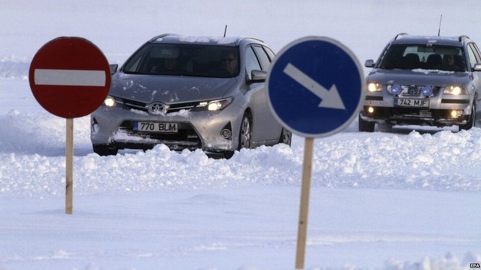 Cars on the first ice road of the year, from Haapsaly to Peninsula, Estonia 16 January 2016. In cold winters there is permit to open official ice roads on the Baltic Sea between mainland Estonia and the islands of Hiiumaa,