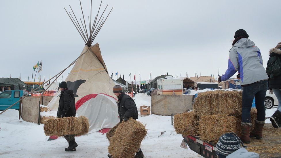 Activists deliver straw to be used for insulation at Oceti Sakowin Camp on the edge of the Standing Rock Sioux Reservation on December 2, 2016 outside Cannon Ball, North Dakota