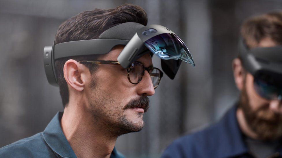 Two men wearing HoloLens 2 headsets