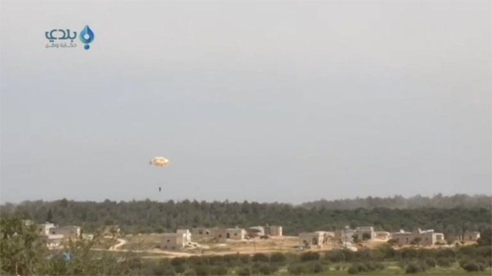 Frame from a video purporting to show the pilot parachuting after his plane was brought down