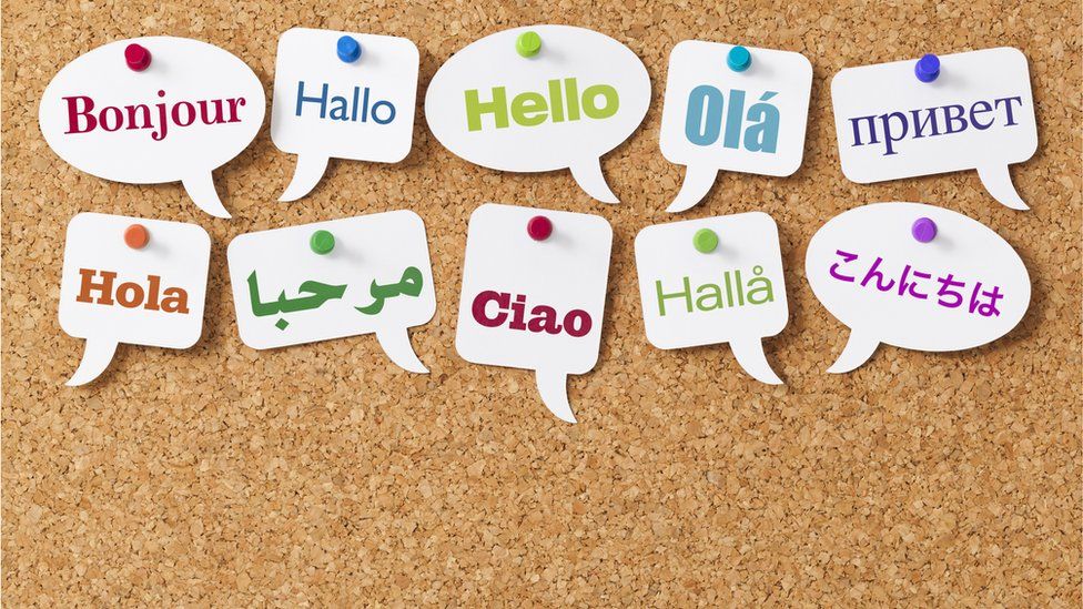A group of white speech bubbles with "hello" written in several languages