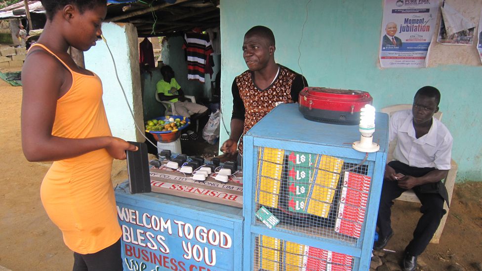 Liberian Moses Tamba selling mobile phone accessories in the capital, Monrovia. Photo: Jonathan Paye-Layleh