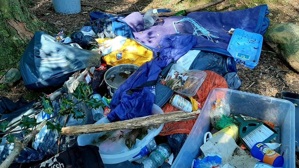 Discarded tents, plastic boxes and wasted food