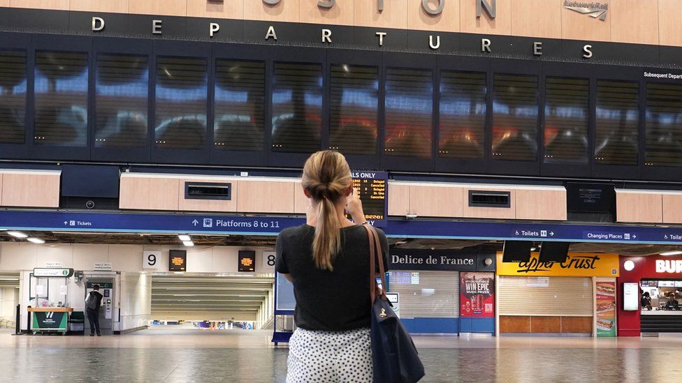 A person at Euston station in London on Tuesday