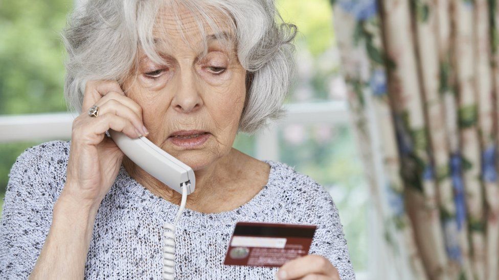 Pensioner with phone and credit card