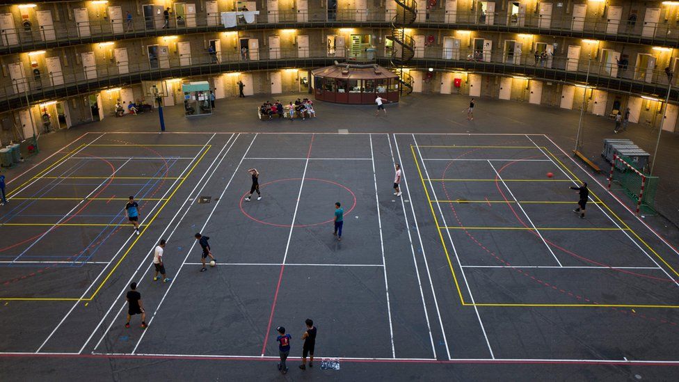 Refugees and migrants play football at the former prison of De Koepel in Haarlem, Netherlands.