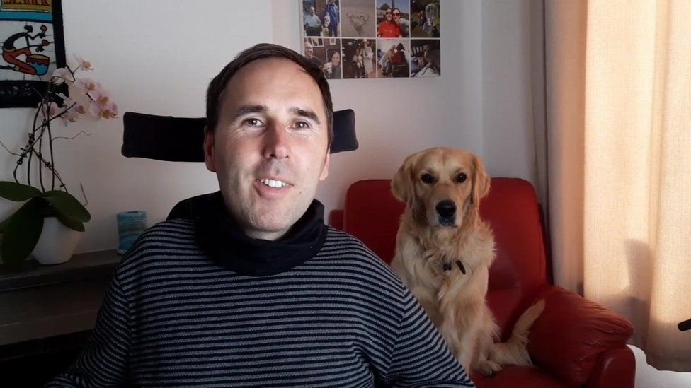 Martyn Sibley at home with his dog