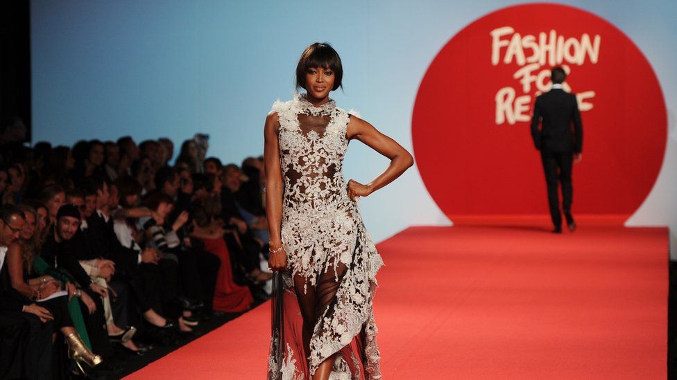 Naomi Campbell walks down a catwalk for a Fashion for Relief event