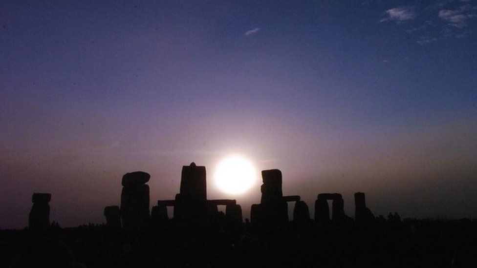 Sun rising above Stonehenge