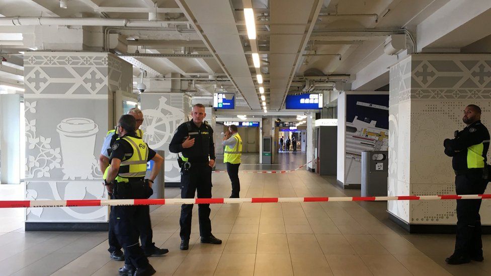 Security officials cordon off an area inside The Central Railway Station in Amsterdam on August 31, 2018
