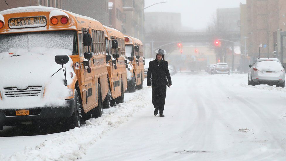 A man walks through the snow in New York City on Tuesday