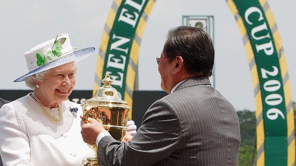 Queen Elizabeth II presenting the Queen Elizabeth II Cup to a race winner at the Singapore Turf Club in March 2006.